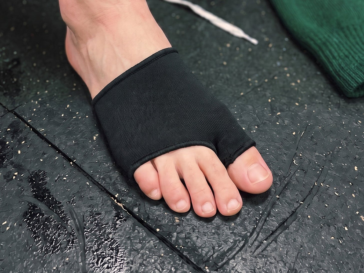 The Olyra Blister Sleeve on a bare foot, seen from above