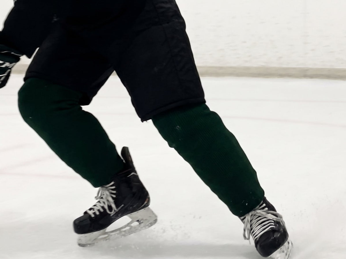 Hockey skate pushing off on the ice, seen from a low angle