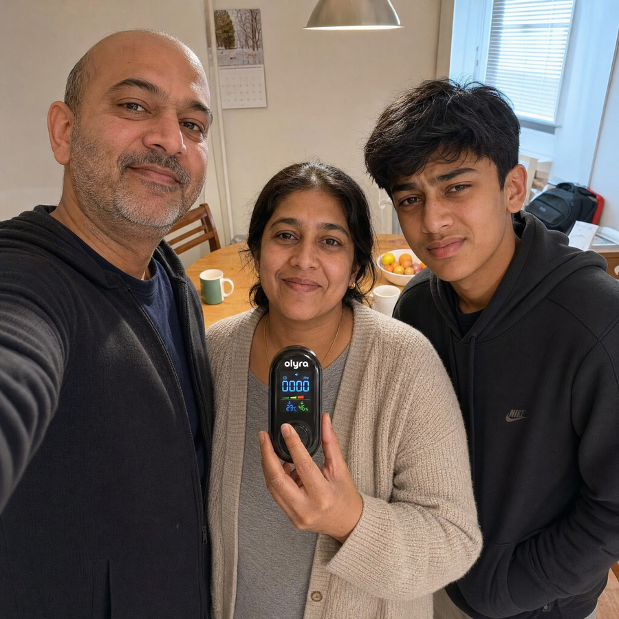 A family of three holding the TrueDetect detector in their kitchen.